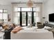 Modern living room with patio views, a designer chandelier, and ample seating at 877 N East St # 103, Indianapolis, IN 46202