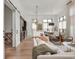 Open-concept living space with a kitchen, modern lighting and access to patio at 877 N East St # 103, Indianapolis, IN 46202