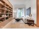 Bright and airy living room with built-in shelving and a large window with backyard views at 877 N East St # 103, Indianapolis, IN 46202