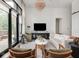 Open living room featuring floor-to-ceiling glass doors and a designer chandelier at 877 N East St # 103, Indianapolis, IN 46202