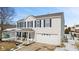 Charming two-story home with blue shutters, a welcoming front porch, and a well-maintained lawn in winter at 10404 Kings Gap Way, Indianapolis, IN 46234