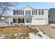 Charming two-story home featuring a covered porch and a two-car garage at 10404 Kings Gap Way, Indianapolis, IN 46234