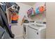 Functional laundry room equipped with modern washer and dryer and ample shelving for storage at 10404 Kings Gap Way, Indianapolis, IN 46234