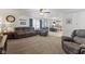Inviting living room with plush seating, ceiling fan, and an open layout to the kitchen at 10404 Kings Gap Way, Indianapolis, IN 46234
