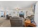 Spacious living room featuring comfortable seating, a ceiling fan, and neutral carpeting at 10404 Kings Gap Way, Indianapolis, IN 46234
