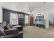 Comfortable living room with plush carpeting, ceiling fan and large windows for ample natural light at 10404 Kings Gap Way, Indianapolis, IN 46234