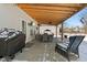 Relaxing outdoor patio with a wooden pergola, dining set, and comfortable seating at 10404 Kings Gap Way, Indianapolis, IN 46234