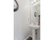 Powder room featuring pedestal sink, mirror and updated fixtures at 10404 Kings Gap Way, Indianapolis, IN 46234