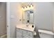 A bathroom with a single sink vanity and ample lighting above the mirror at 10669 Springston Ct, Fishers, IN 46037