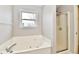 Bright bathroom features a jacuzzi tub and a shower at 10669 Springston Ct, Fishers, IN 46037