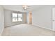 Neutral carpeted bedroom offers a ceiling fan, door and a window at 10669 Springston Ct, Fishers, IN 46037