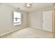 Neutral carpeted bedroom offers a ceiling fan, light paint and a window at 10669 Springston Ct, Fishers, IN 46037