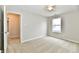Carpeted bedroom with a window, ceiling fan, and a view into the hallway at 10669 Springston Ct, Fishers, IN 46037