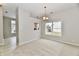 Bright dining room with natural light, neutral colors, and an open view into the kitchen with wood look floors at 10669 Springston Ct, Fishers, IN 46037