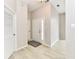 Welcoming entryway featuring wood-look floors, neutral walls, and doors leading to various rooms within the home at 10669 Springston Ct, Fishers, IN 46037