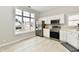 Well-lit kitchen with white cabinets, stainless steel appliances, and a large window offering plenty of natural light at 10669 Springston Ct, Fishers, IN 46037