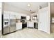 Bright kitchen features stainless steel appliances, white cabinetry, and plenty of space for meal preparation and casual dining at 10669 Springston Ct, Fishers, IN 46037