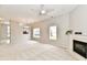 Bright living room featuring a fireplace, a ceiling fan, and lots of natural light at 10669 Springston Ct, Fishers, IN 46037