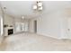 Spacious living room with a fireplace, ceiling fan, and access to an outdoor patio at 10669 Springston Ct, Fishers, IN 46037