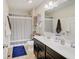 This bathroom features a double sink vanity and a shower tub with a shower curtain at 1083 Margate Dr, Greenwood, IN 46143