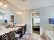 Well-lit bathroom features double vanity and a glimpse into the main bedroom and tub/shower at 1083 Margate Dr, Greenwood, IN 46143