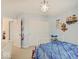 Bright bedroom with a closet featuring paneled doors, neutral carpet, and -themed decorations and a whimsical light fixture at 1083 Margate Dr, Greenwood, IN 46143