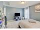 Carpeted secondary bedroom featuring a large window, lots of light, and a television at 1083 Margate Dr, Greenwood, IN 46143