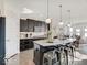 Modern kitchen with granite countertops, a large island with seating, and sleek, dark cabinetry at 1083 Margate Dr, Greenwood, IN 46143