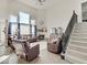 Bright and airy living room featuring a fireplace, large windows, comfortable seating, and modern decor, perfect for relaxing at 1083 Margate Dr, Greenwood, IN 46143