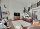 Spacious living room with a fireplace, large windows, staircase and comfortable seating for relaxing and entertaining guests at 1083 Margate Dr, Greenwood, IN 46143