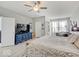 Spacious main bedroom featuring a ceiling fan, a blue dresser, and a comfortable sitting area with natural light at 1083 Margate Dr, Greenwood, IN 46143