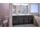 Elegant bathroom with a dual vanity, framed mirrors, and neutral walls with built in shelves at 12991 Pennington Rd, Fishers, IN 46037