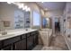 Luxurious bathroom features double vanity, built in shelves, a soaking tub, and glass shower at 12991 Pennington Rd, Fishers, IN 46037