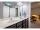 Bathroom with a dual sink vanity, large mirror, and ample lighting for a functional and modern design at 12991 Pennington Rd, Fishers, IN 46037