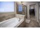 Bright bathroom showcasing a soaking tub, separate shower, and access to the walk-in closet at 12991 Pennington Rd, Fishers, IN 46037