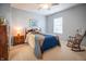 Relaxing bedroom featuring a rocking chair and a bed dressed in a blue and beige coverlet at 12991 Pennington Rd, Fishers, IN 46037