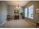 Bright dining room with a chandelier, neutral walls, and large windows offering plenty of natural light at 12991 Pennington Rd, Fishers, IN 46037