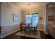 Cozy dining area features a wood table, decorative rug, and modern lighting at 12991 Pennington Rd, Fishers, IN 46037