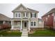 Charming two-story home with neutral siding, black shutters, covered porch, and well-manicured lawn at 12991 Pennington Rd, Fishers, IN 46037