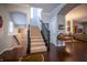 Spacious foyer boasts hardwood flooring, a staircase, and access to multiple living areas at 12991 Pennington Rd, Fishers, IN 46037