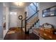 Inviting foyer featuring hardwood floors, a staircase with iron railings, and elegant decor at 12991 Pennington Rd, Fishers, IN 46037