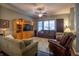 Inviting living room with hardwood floors, a ceiling fan, comfortable seating, and a built-in entertainment center at 12991 Pennington Rd, Fishers, IN 46037