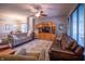 Spacious living room with hardwood floors, a ceiling fan, comfortable seating, and an entertainment center at 12991 Pennington Rd, Fishers, IN 46037