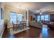 Spacious open-concept living room and dining area with hardwood floors, ceiling fan, and plenty of natural light at 12991 Pennington Rd, Fishers, IN 46037