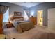 Well-lit bedroom features carpet, windows with curtains, and access to the bathroom at 12991 Pennington Rd, Fishers, IN 46037