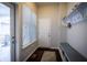 Mudroom featuring a bench with storage, hooks, a window, and an exterior door to the outside at 12991 Pennington Rd, Fishers, IN 46037