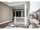 View of the covered porch showing detailed trim, lighting, brick accents and a ceiling fan at 12991 Pennington Rd, Fishers, IN 46037