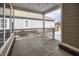 Spacious covered patio with concrete flooring, complemented by white railings and brick accents at 12991 Pennington Rd, Fishers, IN 46037