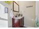 Charming bathroom featuring a wood vanity with a stone countertop and modern fixtures at 1390 Greenfield Ave, Noblesville, IN 46060