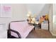 Cozy bedroom with a futon, butterfly art, and unique geometric wall design at 1390 Greenfield Ave, Noblesville, IN 46060